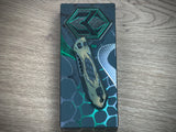 Heretic Knives Jinn Manual Button Lock (Gold & Green Cel Shade Carbon Breach)