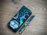 Heretic Knives Jinn Manual Button Lock (Gold & Green Cel Shade Carbon Breach)